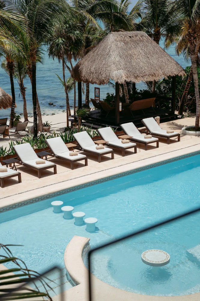 The pool and lounge chairs by the beach